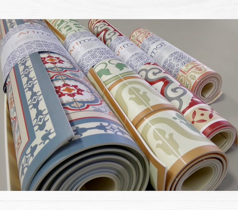 May include: Four rolled up floor mats with a tile pattern. The mats are in various colors, including blue, green, red, and white. The mats are labeled "Artmat".