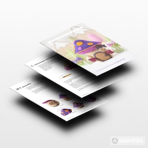 May include: A stack of three white papers with the title "Mushroom House" and crochet pattern instructions. The top paper shows a crocheted mushroom house with a purple roof and brown base. The text "Crochet pattern by AradiyaToys" is also visible.