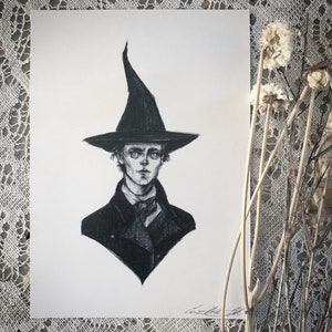 May include: A black and white pencil drawing of a person wearing a black pointed hat and a black coat. The person has short, dark hair and a serious expression.