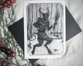 May include: A black and white Krampus greeting card with a detailed illustration of the Krampus figure in a snowy forest scene. The card includes the text "Greetings from Krampus" and is paired with a black envelope.