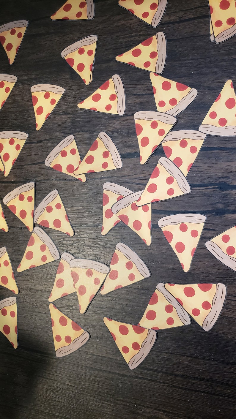 May include: A collection of pizza slice stickers on a dark wood surface. The stickers are yellow with red pepperoni and a brown crust.