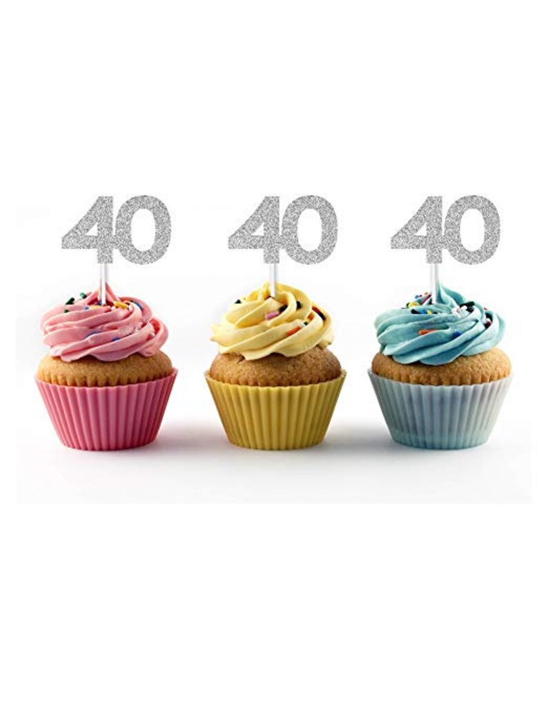 May include: Three cupcakes with silver glitter '40' cake toppers. The cupcakes are frosted in pink, yellow, and blue.