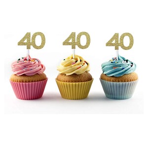May include: Three cupcakes with pink, yellow, and blue frosting. Each cupcake has a gold glitter '40' topper.