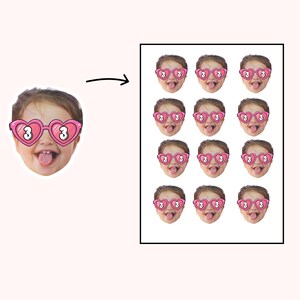 May include: A sticker sheet featuring a child's face with heart-shaped sunglasses. The sunglasses are pink with the number 3 in white. The child is sticking their tongue out. The sheet contains 12 stickers.