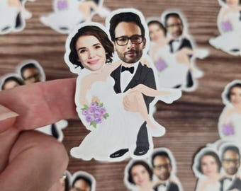 May include: A set of wedding favor stickers featuring a cartoon couple in a wedding dress and tuxedo. The bride is holding a bouquet of purple flowers. The stickers are printed on white paper.