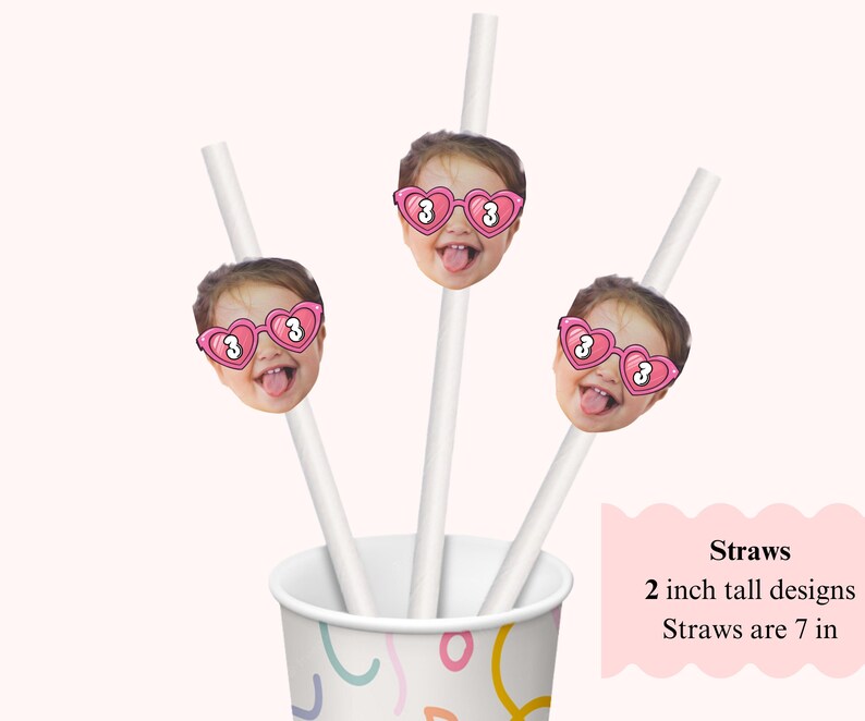 May include: White straws with a child's face wearing pink heart-shaped sunglasses with the number 3. The straws are placed in a patterned cup. The text on the image says "Straws, 2 inch tall designs, Straws are 7 in."