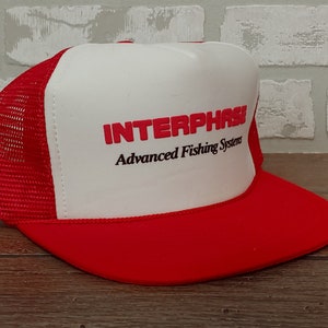 May include: A red and white trucker hat with the text "INTERPHASE Advanced Fishing Systems" embroidered on the front.