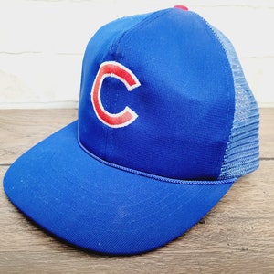 May include: A blue and red baseball cap with a mesh back and a large "C" embroidered on the front.