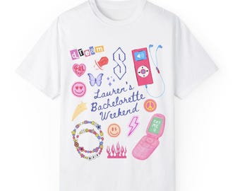 May include: White t-shirt with a colorful graphic design featuring the text "Lauren's Bachelorette Weekend" and various 90s and early 2000s themed icons, including a butterfly, a peace sign, a star, a smiley face, a cell phone, a cassette player, and a heart.