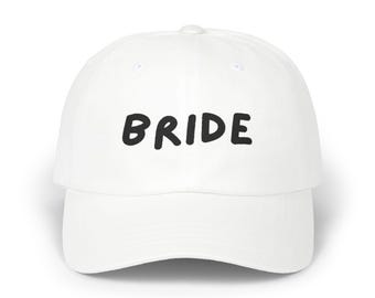 May include: White baseball cap with the word "BRIDE" in black lettering.