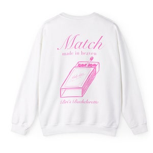 May include: White sweatshirt with a pink graphic of a matchbox with the text "Match made in heaven" and "Bri's Bachelorette" printed on the front.