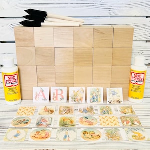 May include: A craft project to create a personalized wooden block set with Peter Rabbit themed images. The set includes 24 wooden blocks, 2 bottles of Mod Podge Matte, 3 paint brushes, and 20 Peter Rabbit themed images. The images include letters, animals, and patterns.