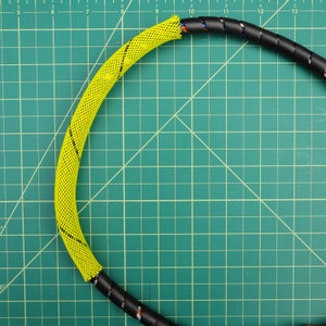 May include: Yellow and black braided cable sleeve. The sleeve is flexible and can be used to protect and organize cables.