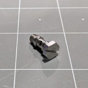 May include: A silver metal fitting with a hexagonal head and a threaded end. The fitting has a small hole in the side.