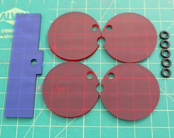 May include: Four red plastic circles with grid patterns and holes. The circles are arranged in a square pattern. There are five black rubber o-rings to the right of the circles.