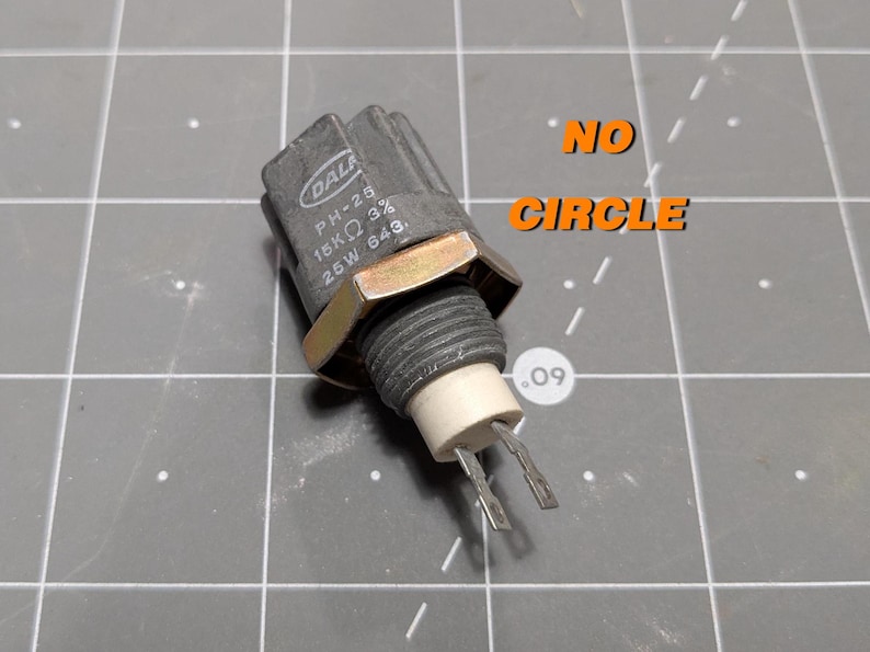 May include: A gray electrical component with the text "DALI PH-25 18K&Omega; 3% 25W 643." printed on it. The component has a gold-colored nut and two metal prongs.