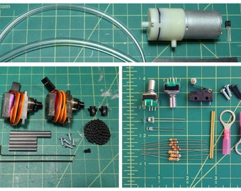 May include: A collection of electronic components and tools, including a small pump, tubing, servo motors, resistors, switches, screws, and other hardware, arranged on a green grid surface. Ideal for DIY electronics projects.