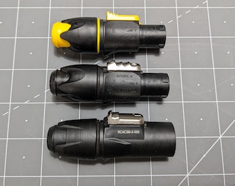 May include: Three black electrical connectors with yellow and silver accents. The connectors have the text "JET" and model numbers "NAC3FX-W", "RCAC3M-X-000", and "JET" printed on them.