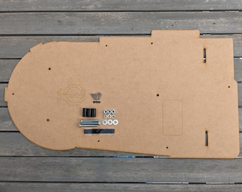 May include: A brown wooden base with cutouts and holes for a pinball machine. The base is accompanied by a set of hardware including screws, nuts, and washers.