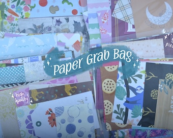 Peut inclure: Un sac en plastique transparent rempli de morceaux de papier à motifs colorés. Le sac est étiqueté "Paper Grab Bag" et comprend une note qui dit "haute qualité !" et "50 pièces".
