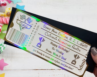May include: A rectangular holographic ticket with black text reading Start Your Engines, 3, 2, 1, Go!!!!!, California Adventure Awaits, Happy Birthday!, To: Wesley, From: Mom & Dad, and Get Ready to zoom into a fast, and fun time!, featuring trophy icons.