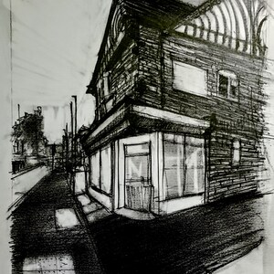May include: A charcoal sketch of a building with a shopfront on a street corner. The building has a gabled roof and a timber-framed appearance. The windows of the shop are large and rectangular. The artwork is in black and white.