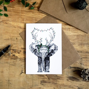 Carte de voeux de Noël éléphant avec bois de renne