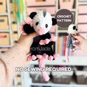 May include: Crochet pattern for a black, white, and pink opossum amigurumi toy. The pattern includes instructions for making a larger and smaller version of the opossum. The text "CROCHET PATTERN" and "NO SEWING REQUIRED" is visible in the image.