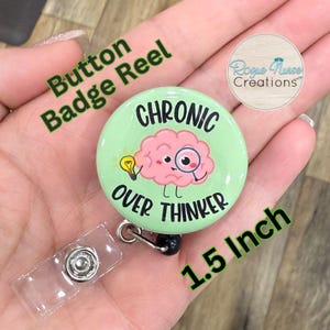 May include: A green button badge reel with a 1.5 inch diameter button featuring a cartoon brain with a lightbulb and magnifying glass. The button text reads "Chronic Over Thinker".