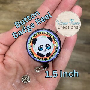 May include: A 1.5 inch button badge reel with a black and white panda with rainbow stripes and the text "I was led to believe that there would be serotonin".