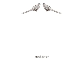 May include: A white card features two detailed illustrations of pheasants facing each other. The birds are rendered in a detailed, brown line art style. The text "Brock Toner" is printed in a brown serif font at the bottom.