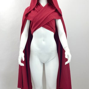 style 1: scarf piece crossed across the chest and tied in the back with hood up