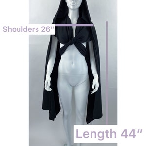 May include: Black hooded cape with a tied front, shoulders measure 26 inches and length is 44 inches.