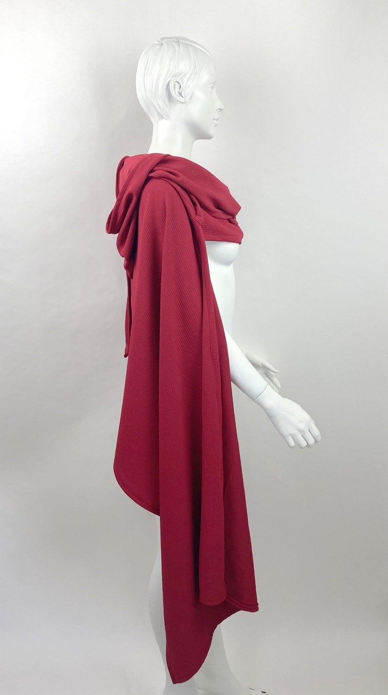 side view showing asymmetrical style of cloak shape - shorter in the back, and longer in the front