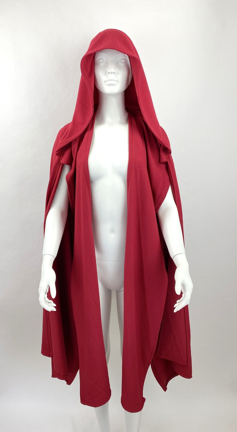 Style: hood up, scarf pieces falling down from shoulders to floor
