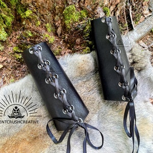 Leather bracers showing the lacing and grommets