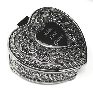 May include: Silver heart-shaped trinket box with an ornate design and an engraved message that reads "Addie I love Grandma".