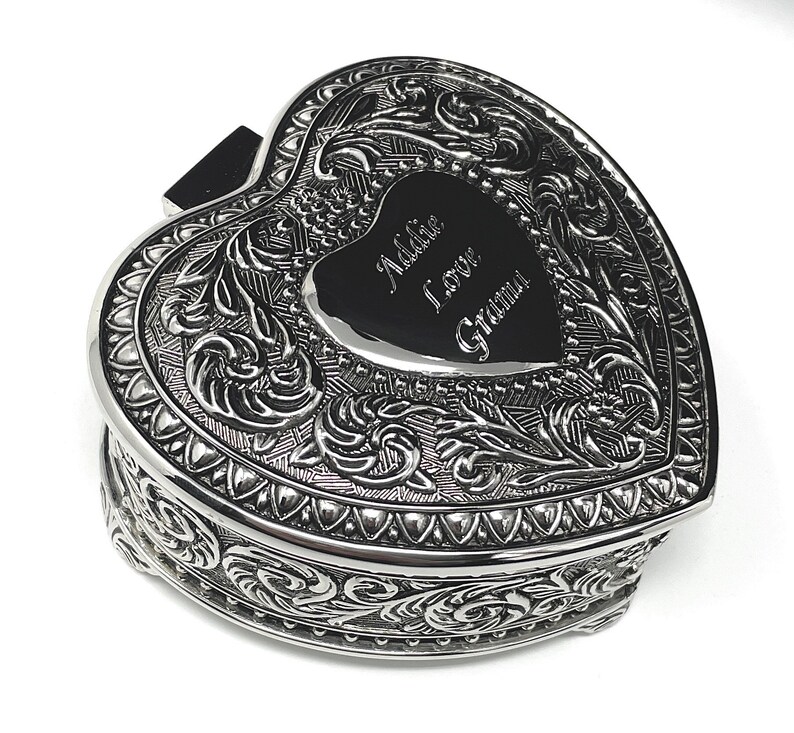 May include: Silver heart-shaped trinket box with an ornate design and an engraved message that reads "Addie I love Grandma".