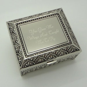 May include: Silver keepsake box with an ornate design and an engraved message that reads "You gave me wings and taught me to fly."