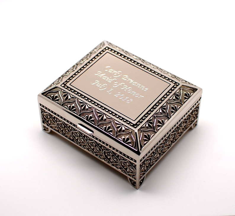 May include: Silver keepsake box with an ornate design and a personalized inscription that reads "Lori &  Brennan Maid of Honor Jul 31, 2012".