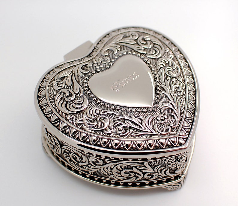 May include: Silver heart-shaped trinket box with an ornate design and the name "Fiona" engraved on the lid.