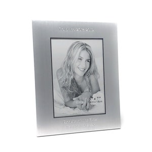 May include: Silver photo frame with a black and white photo of a woman. The frame has the text "Gold Team 2018-2019" and "Rookie of the Year,  [Name]" engraved on it. The photo is 5" x 7" (13cm x 18cm).