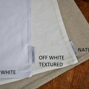 May include: Three fabric swatches in different shades of white. The swatches are labeled "Bright White", "Off White Textured", and "Natural".