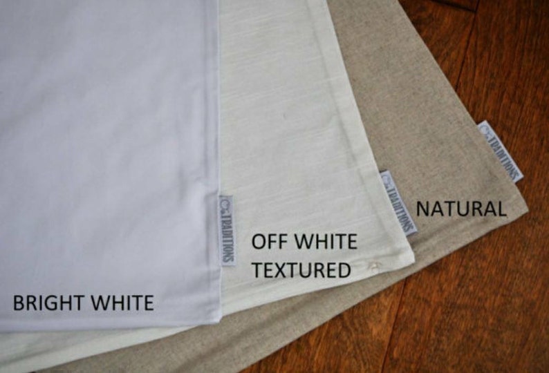 May include: Three fabric swatches in different shades of white. The swatches are labeled "Bright White", "Off White Textured", and "Natural".
