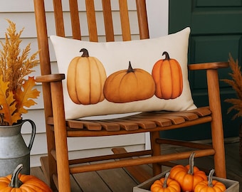 May include: A wooden rocking chair with a cream-colored pillow featuring three orange pumpkins. Several pumpkins of varying sizes are arranged on the porch, including a large one and a crate filled with smaller ones. Autumn decor.