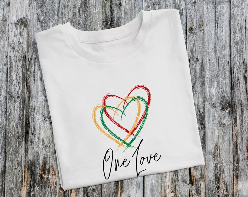 May include: White t-shirt with a green, red, and yellow heart design and the text "One Love" printed on the front.