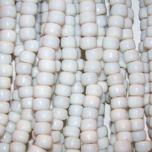 May include: A strand of white seed beads, perfect for jewelry making or crafting projects.