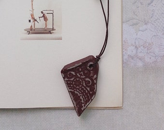 Asymmetrical burgundy ceramic handmade pendant, necklace.