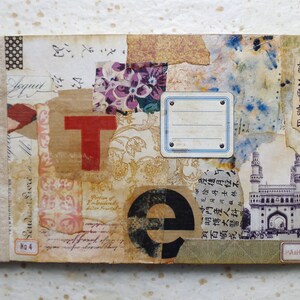 May include: A handmade journal with a brown cover featuring a collage of paper scraps, including a red letter "T", a black letter "e", and a black and white image of a building. The journal has a brown tassel and the text "No. 4" is visible on the cover.