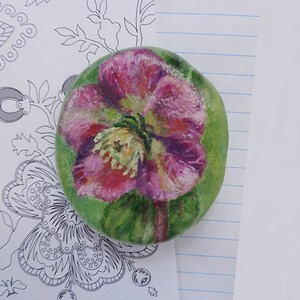 Ceramic rock. Pink purple flower painting on clay paperweight. Hand painted with acrylics.